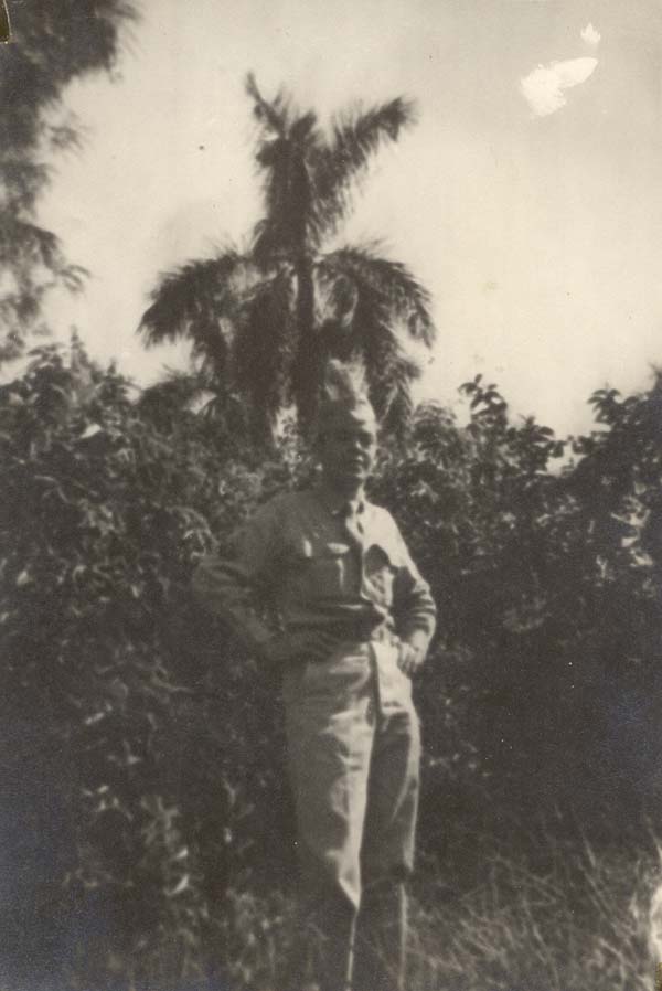 Frank in uniform in a tropical setting