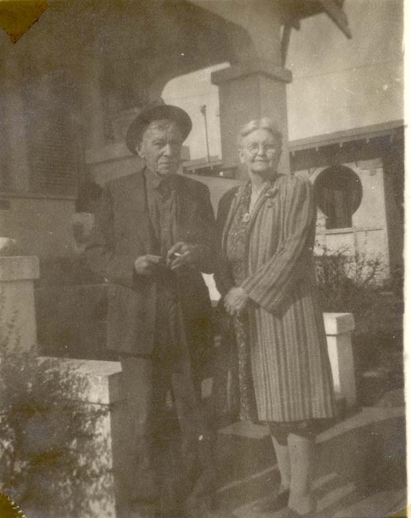 William Henry and Bertha in front of a house