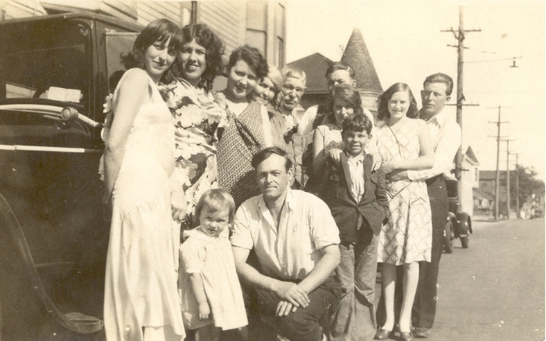 A number of members of the Boyd family by a car
