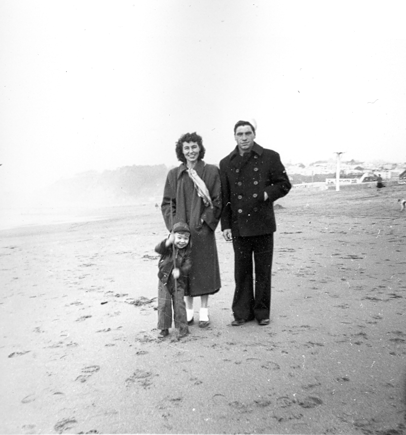 Florence and her son Frank standing with Pete on a beach