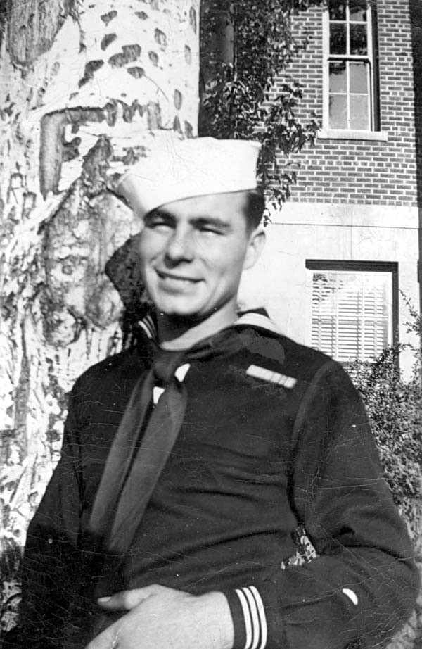 John in uniform by a tree