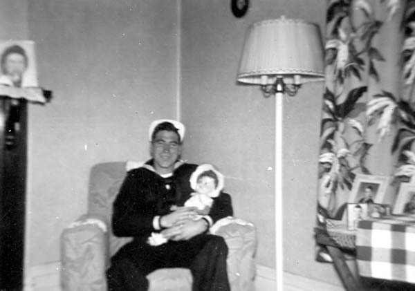 Pete in uniform, holding a doll